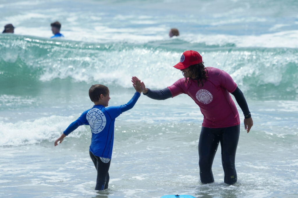 Happy student and instructor high-fiving