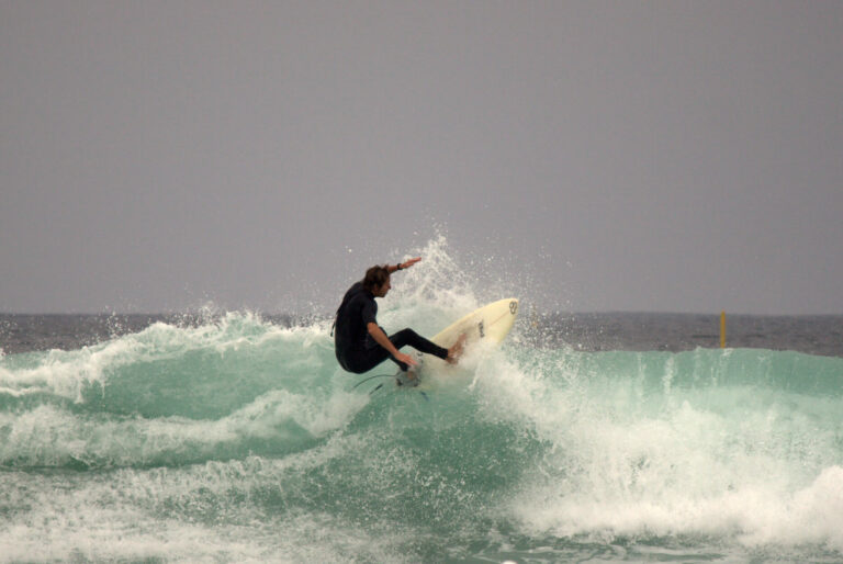 Surfer riding waves at Black’s Beach