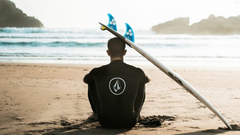 Men with surfboard in front sea