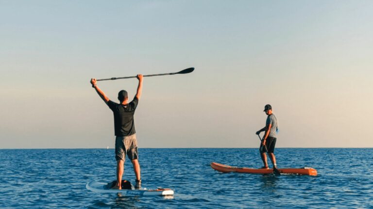 Father surfing with other people