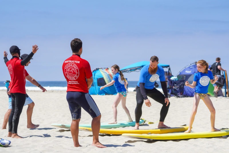 Surf instructors teaching kids surfing fundamentals