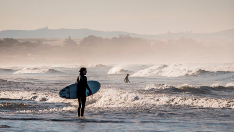 surfer waiting to surf on beach