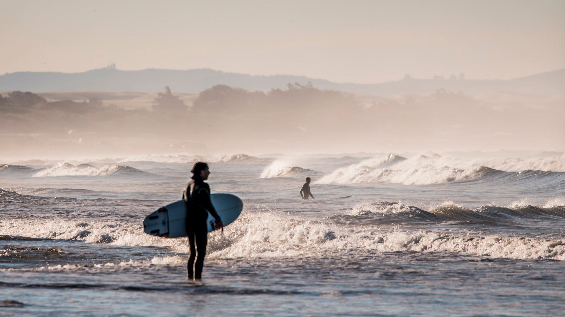 surfer waiting to surf on beach