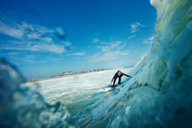 Woman riding along a wave on a surfboard