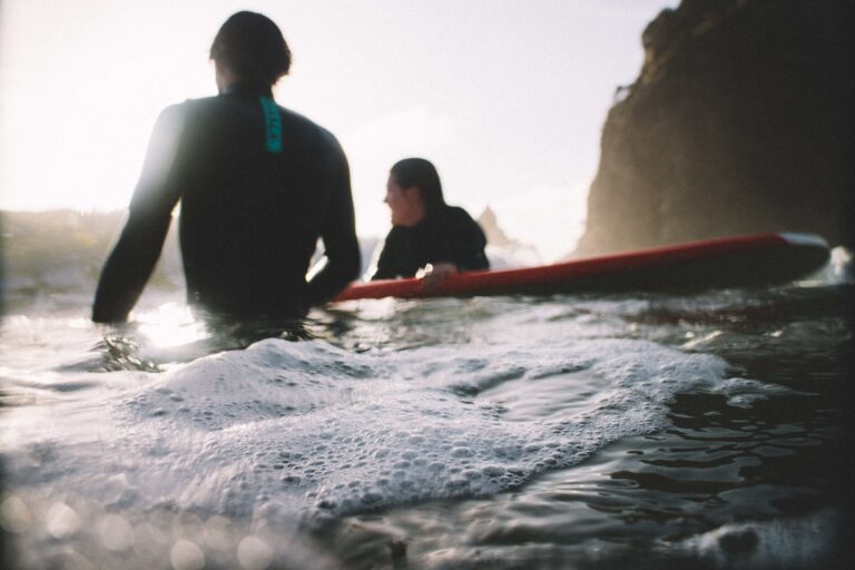 2 surfers in the water assessing the water conditions.