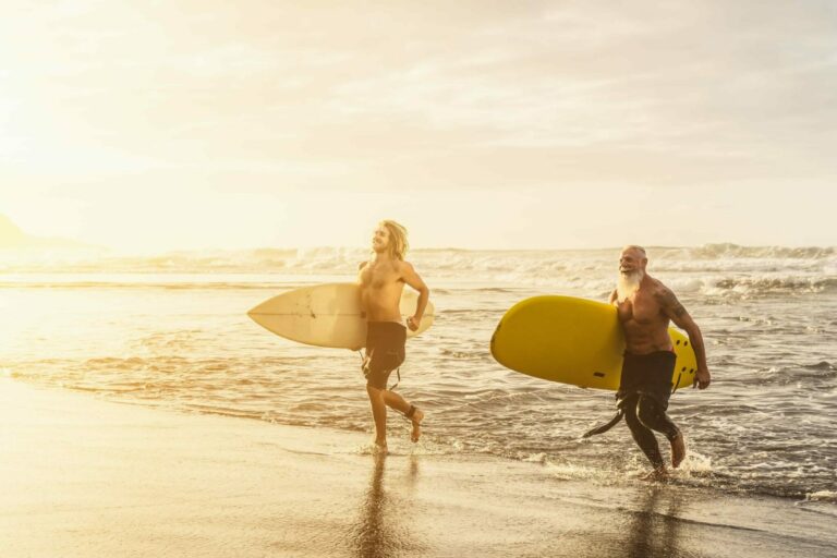Young man with a shortboard and an older man with a longboard