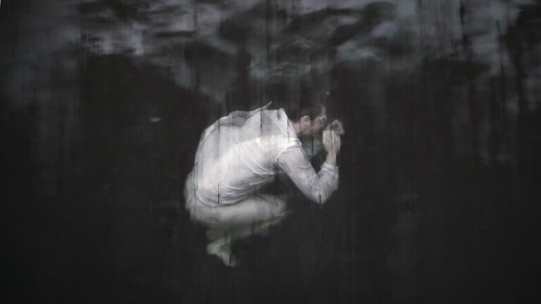 Man in suit floating in the water