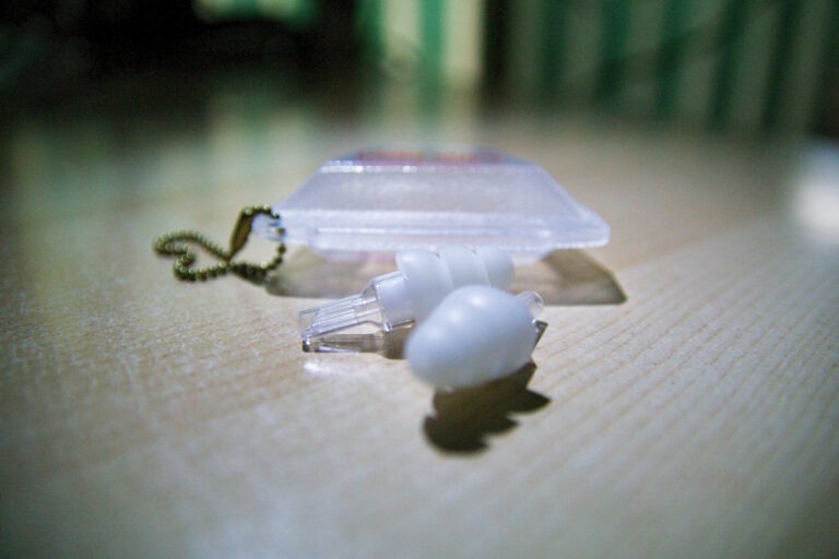 White surfer earplugs