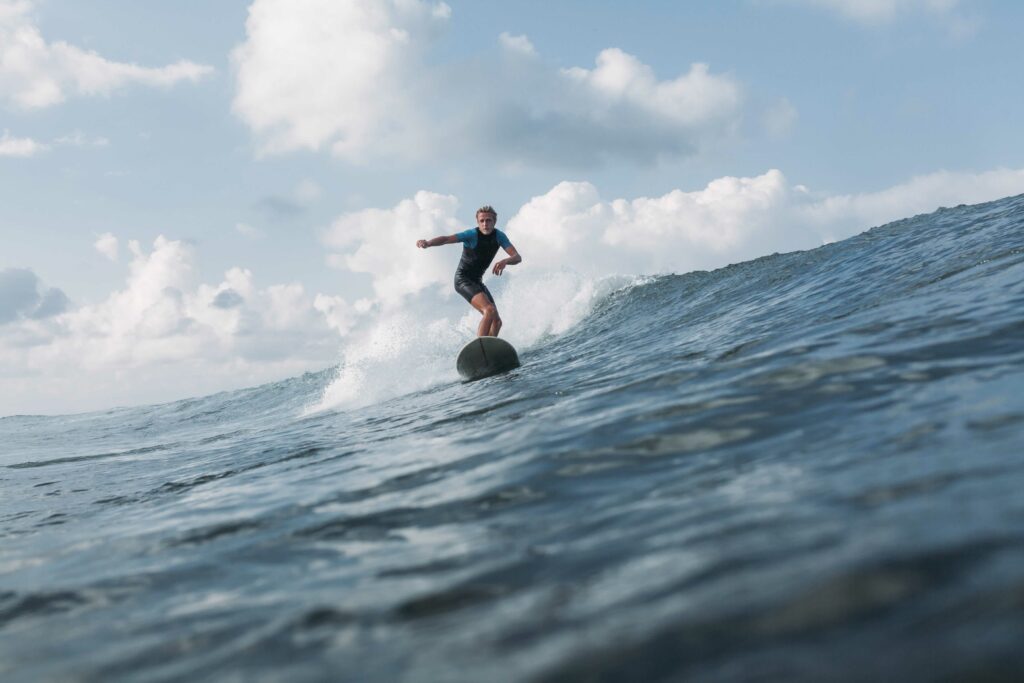 Surfer smoothly riding down a wave