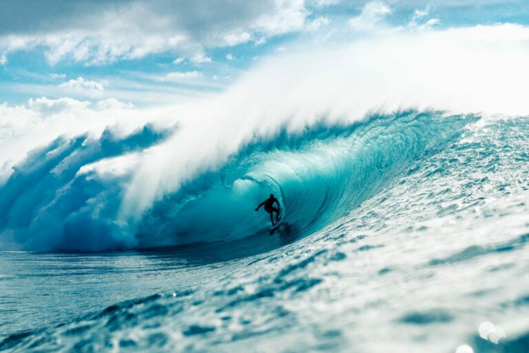 Surfer riding big wave