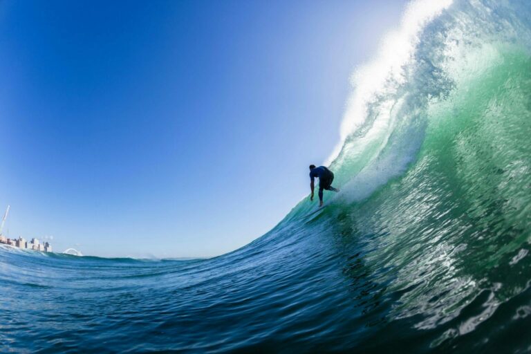 Surfer dropping in on a large wave.